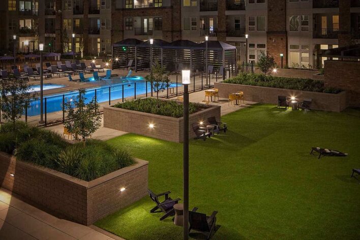 commercial apartment building with artificial grass lawn